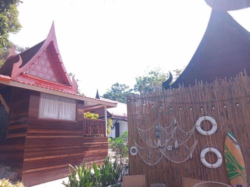a wooden fence in front of a house at Vimarn Samed Resort in Ko Samed