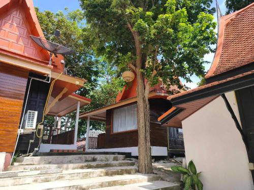 a tree in front of a house with stairs at Vimarn Samed Resort in Ko Samed