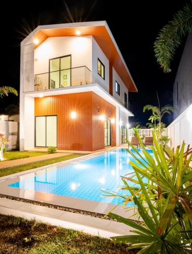 a house with a swimming pool in front of it at Krabi Private Pool Villa 1 by Belcarrra Spaces in Ban Khlong Haeng