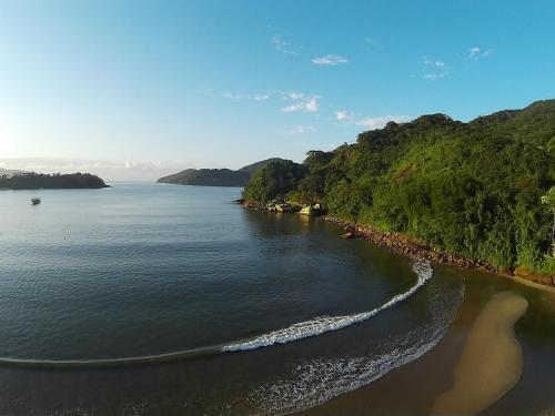 an aerial view of a body of water with trees at Pousada Preamare in Ubatuba