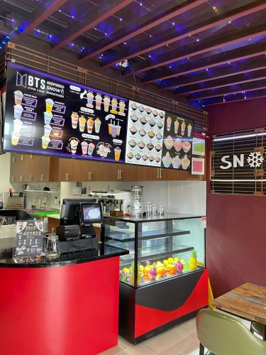 a fast food restaurant with a counter with food at Grand Plaza Hotel in Tumon