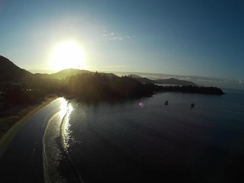 an image of the sun setting over the water at Pousada Preamare in Ubatuba