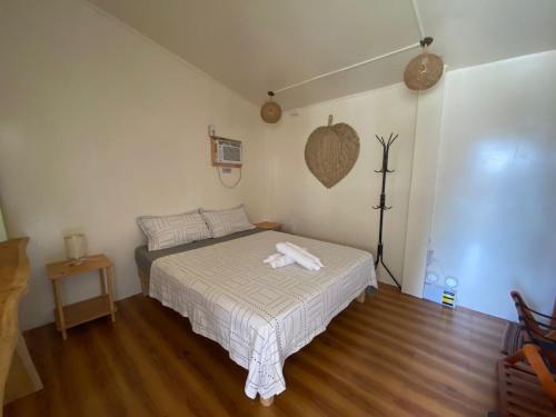 a bedroom with a bed with a towel on it at Free Breakfast Kabayod Place Unit B1 General Luna Siargao in General Luna