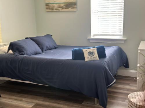 a bed with a blue comforter in a bedroom at 318 E Youngs Ave Unit 8 Salty Shore Retreat Idyllic Studio by the Sea in Wildwood