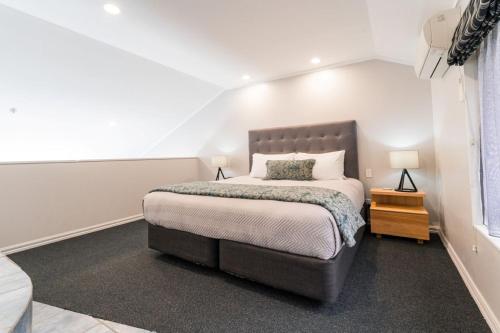 a bedroom with a large bed in a room at Aubyn Court Spa Motel in Palmerston North