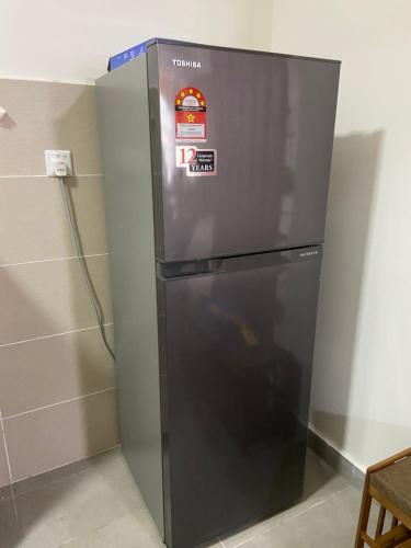 a refrigerator in a room with a wall at Suasana Damai Damansara Damai Petaling Jaya in Petaling Jaya
