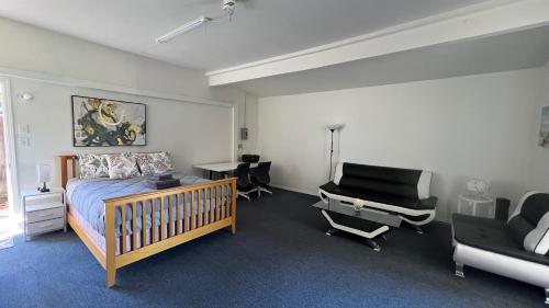 a bedroom with a bed and a desk and chairs at 40223 Fremont Entire Coze 3brs house Free Parking nd AC in Fremont