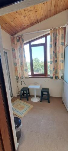 a living room with a table and a window at Holiday House Krapets in Krapets