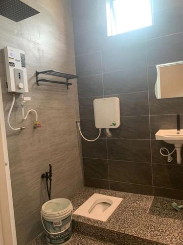 a small bathroom with a toilet and a sink at Homestay Senggarang in Senggarang