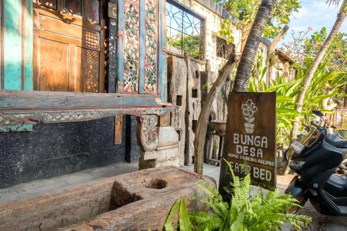 a building with a sign on the side of it at TwoSpaces Living at Bunga Desa, Jimbaran in Jimbaran