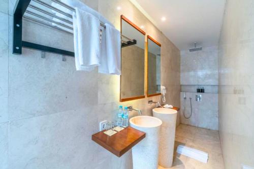 a bathroom with a sink and a toilet and a mirror at Chayanika 3 BR Private Pool Villa With Sea View ZN149 in Ujung