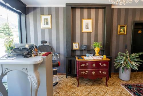 an office with a desk and a computer in a room at VILLA OXA - Boutique Design Hotel in Maria Alm am Steinernen Meer