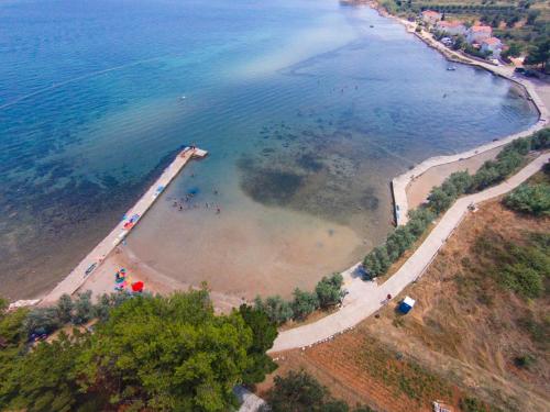 an aerial view of a beach with people in the water at Villa Olive Island in Neviđane