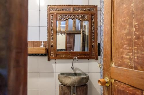 a bathroom with a sink and a mirror at TwoSpaces Living at Bunga Desa, Jimbaran in Jimbaran
