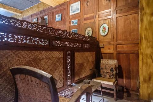 a room with a bed and a table and chairs at TwoSpaces Living at Bunga Desa, Jimbaran in Jimbaran