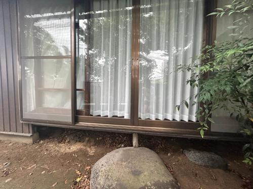 a window with a stone in front of it at 富山県美術館裏の和風宿Hide-inn 隠れ家T #HH8 in Toyama