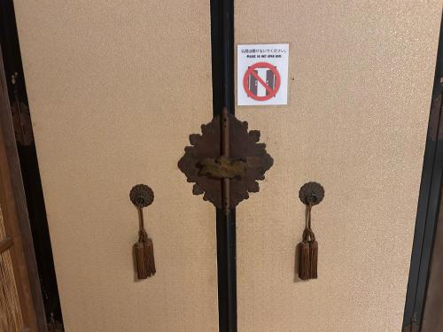 a door with a no parking sign on it at 富山県美術館裏の和風宿Hide-inn 隠れ家T #HH8 in Toyama