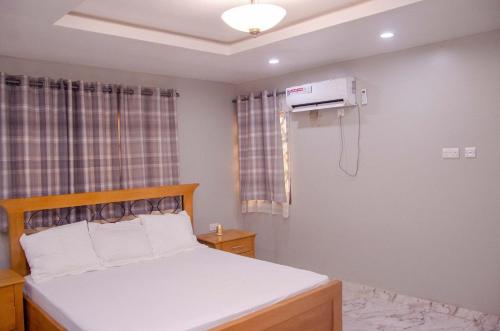 a bedroom with a bed and a air conditioner at The Noble Villa, Ikorodu, Lagos in Ikorodu