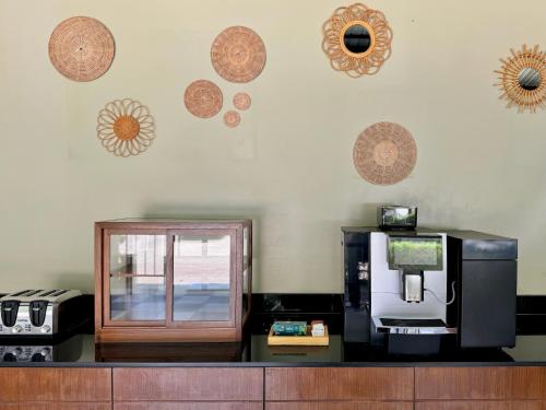 a kitchen with a coffee maker and a microwave on a counter at XAYA Pool Access Resort - Phuket in Phuket