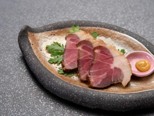 a plate of food with meat and an egg on a table at Kageyu in Isehara