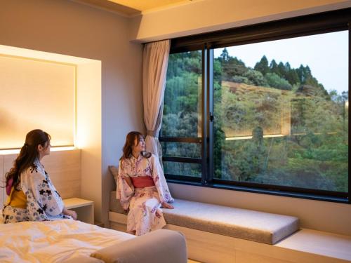 Ένα ή περισσότερα κρεβάτια σε δωμάτιο στο Kirishima Kanko Hotel