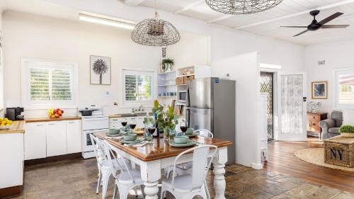 a kitchen with a table and chairs and a refrigerator at Beach Bungalow in Corlette