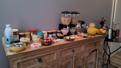 a wooden table with food items on top of it at Mer et Sable B&B in Ville-Pommeroeul