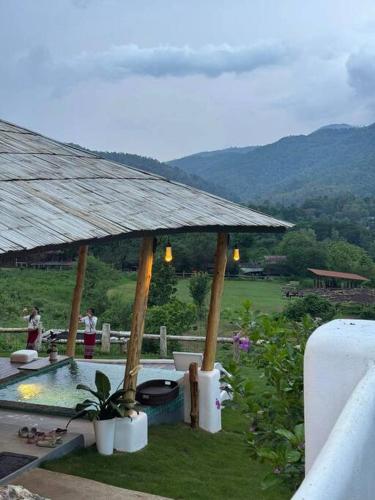 a backyard with a gazebo and a swimming pool at Elephantpoolvilla maetang Chiangmai in Ban Muang Kut