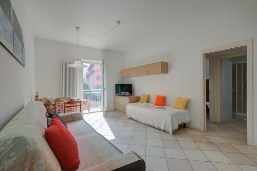 a living room with a couch and a bed at Casa al Cor Apartments in Nago-Torbole