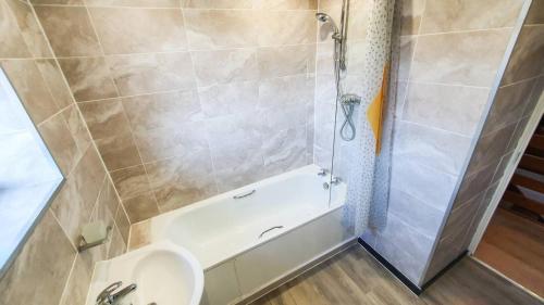 a bathroom with a shower and a toilet and a sink at Cheerful 4-bedroom house in Cheltenham