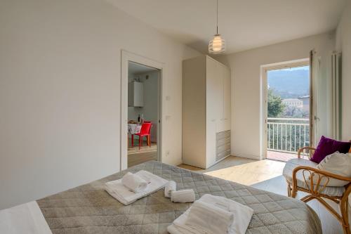 a bedroom with a bed with two towels on it at Casa al Cor Apartments in Nago-Torbole