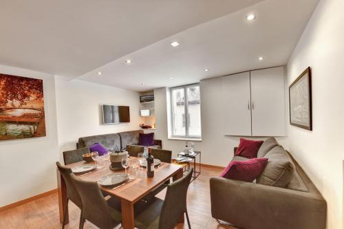 un salon avec une table et un canapé dans l'établissement Cozy apartment between lake and mountains, à Annecy