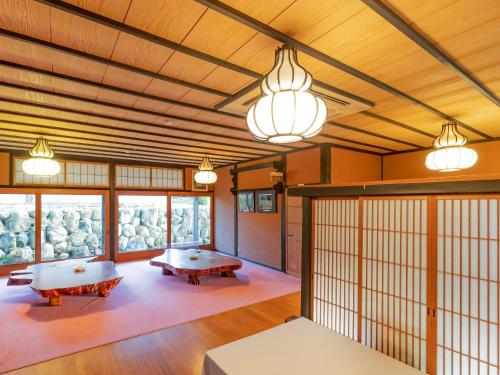 a room with two tables and some lights at 料理旅館 山里料理 いそべ -Ryokan Isobe- in Kami-hiraya