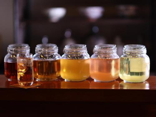 a group of jars of honey on a table at 料理旅館 山里料理 いそべ -Ryokan Isobe- in Kami-hiraya