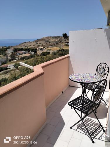 a table and chairs on a balcony with a view at Casa vacanze da francesca 2 in Realmonte