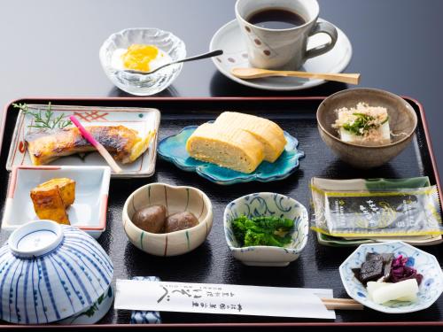 a tray filled with food and a cup of coffee at 料理旅館 山里料理 いそべ -Ryokan Isobe- in Kami-hiraya