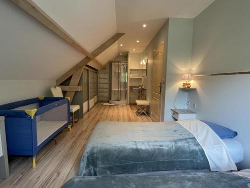 a bedroom with two beds and a attic at La maison de julie in Burosse-Mendousse