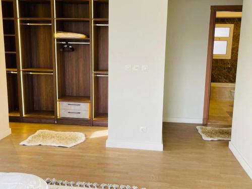a room with wooden shelves and wooden floors at Mivida Emaar New Cairo For Rent in New cairo