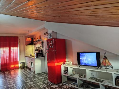 a kitchen with a red refrigerator and a tv at El Akito, Huéscar in Huéscar