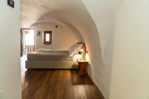 a bedroom with a bed in a white room at Agriturismo Cà Gianin in Vervio