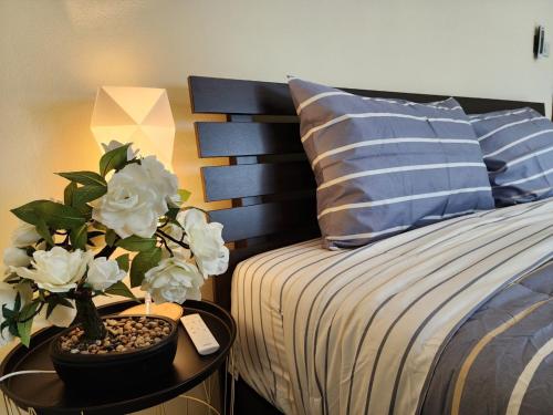 a bedroom with a bed and a table with a potted plant at Boxsoon Nimman 10 3beds 3baths in Chiang Mai
