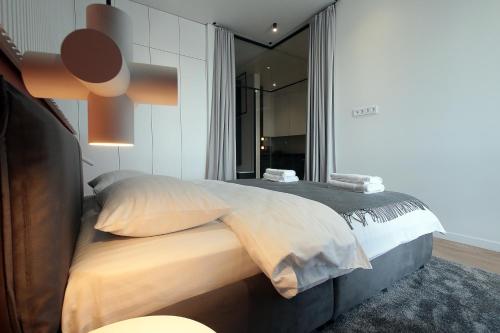 a bedroom with a large bed and a large mirror at FORUM apart in Lviv