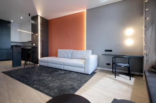 a living room with a white couch and a table at FORUM apart in Lviv