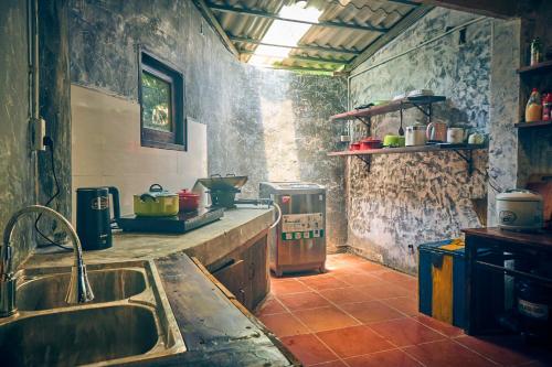 a kitchen with a sink and a stove at Sa Moc - La Maison House & Bungalow in Sa Pa