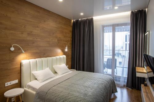 a bedroom with a bed with a wooden wall at FORUM apart in Lviv