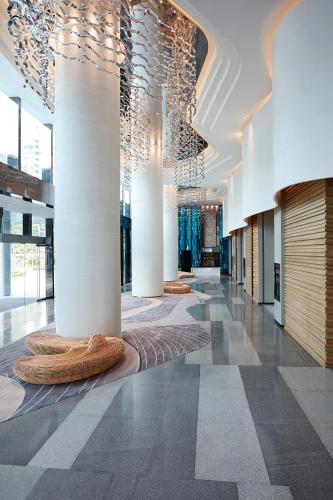 a lobby with columns and lights in a building at The Shanhaitian Resort Sanya, Autograph Collection in Sanya