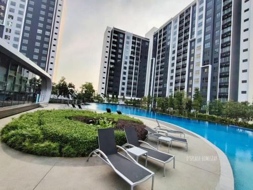 a group of chairs sitting in front of some buildings at D'Splash Homestay SplashMania in Banting