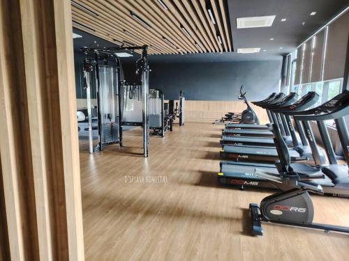 a gym with a row of treadmills and ellipticals at D'Splash Homestay SplashMania in Banting