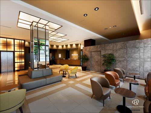 a lobby of a hotel with chairs and tables at Daiwa Roynet Hotel Kyoto-Hachijoguchi in Kyoto