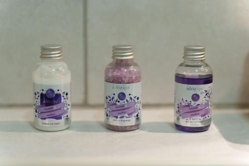 three bottles of purple liquid sitting on a counter at Lara free parking Skadarlija in Belgrade